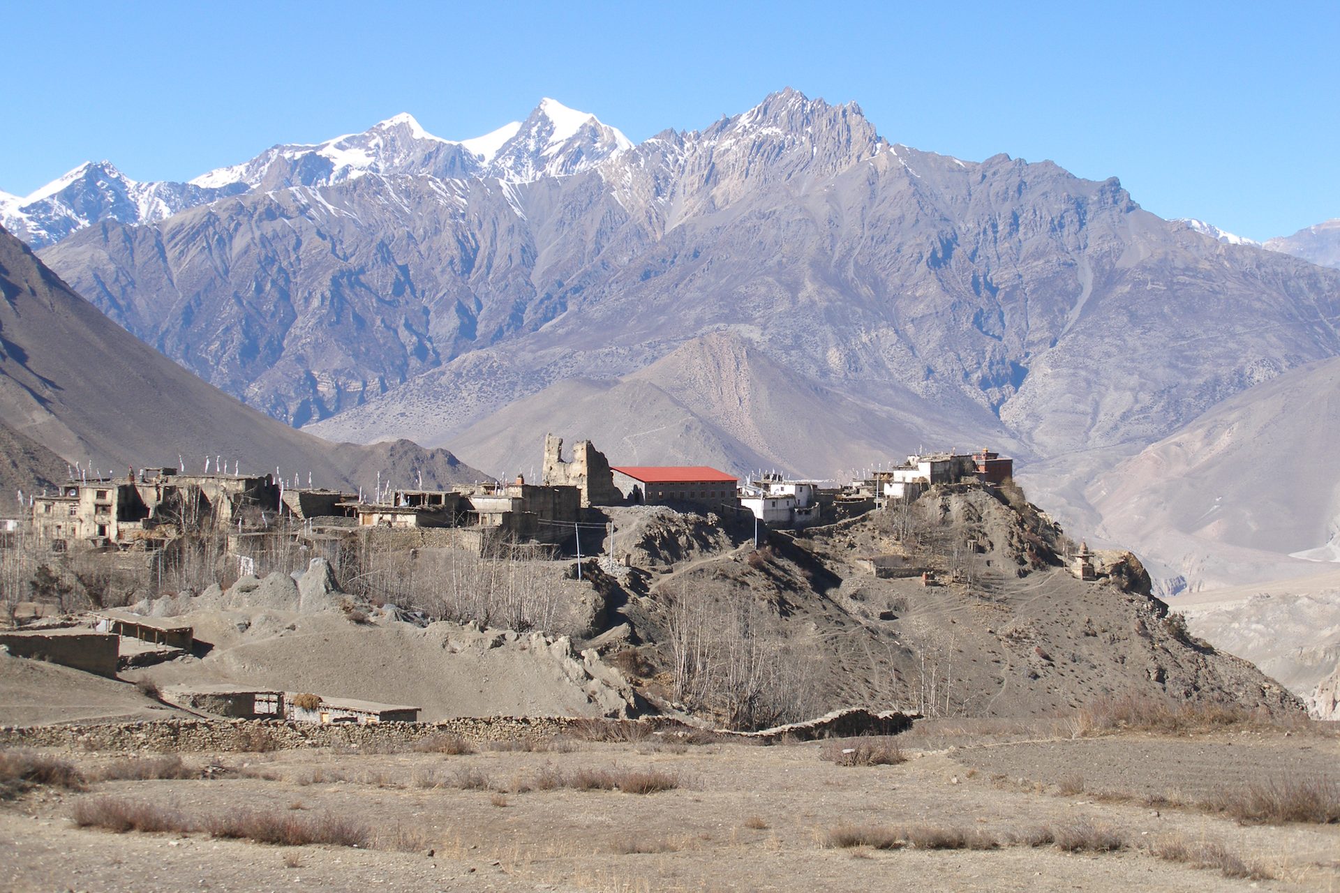 A traditional stone village in the hills. — 7 Best Upper Mustang Trekking Routes for 2026